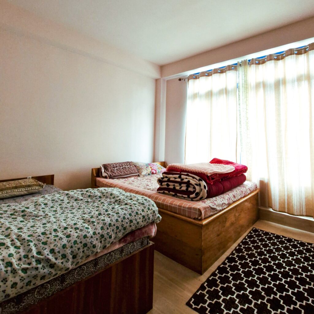 Cozy and inviting room with One single and double bed with large window that let in natural light. The room has a minimalistic design, for homely and comfortable ambiance.